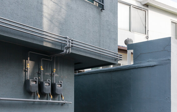 Gas piping installed on the wall of a city building.