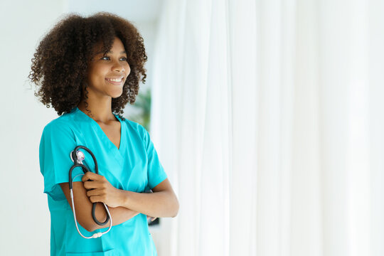 Beautiful American - African black ethnicity female doctor standing in the hospital portrait with copyspace. Surgery female doctor portrait at hospital.