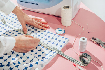 seamstress chalking measurements on material