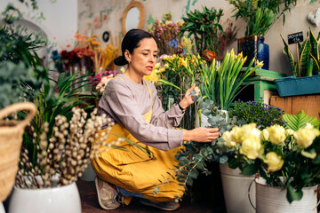Florists woman working at flower a shop.