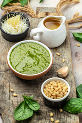 Homemade pesto sauce and ingredients, Traditional Italian pesto recipe for pasta on a dark background, vertical image. top view. place for text