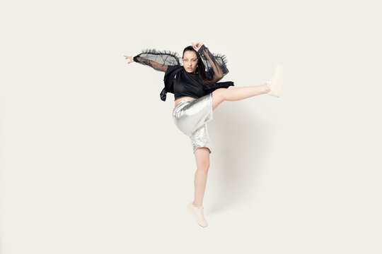 Full length portrait of a joyful young woman jumping