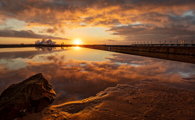 Beautiful landscape view of sunrise at North Narrabeen Rockpool in the Northern Beaches of Sydney,...