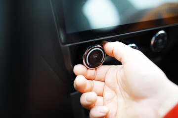 The process of choosing climate control in the car. Various controls in auto switches. Modern car interior
