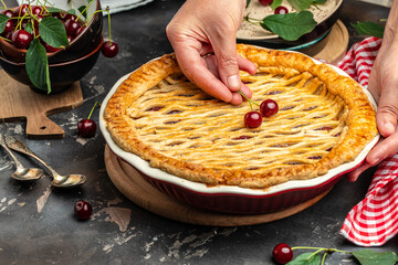 Delicious Homemade Cherry Pie, Flaky Crust, piece on a plate and the whole homemade cherry pie, place for text, top view