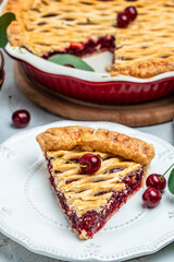cherry pie, Flaky Crust, piece on a plate and the whole homemade cherry pie, place for text, top view