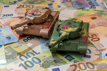 Tanks are on euro bills. Concept: military and financial assistance to Ukraine, high costs of...