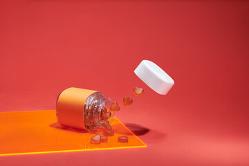  gummy multivitamins in bowls and a spilled bottle