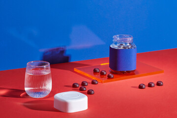 multivitamin gummies with the bottle and the glass of water