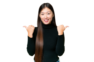 Young Asian woman over isolated chroma key background with thumbs up gesture and smiling