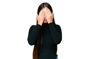 Young Asian woman over isolated chroma key background covering eyes by hands