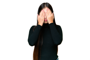 Young Asian woman over isolated chroma key background covering eyes by hands