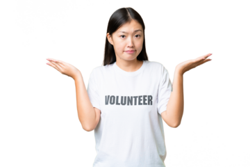 Young volunteer woman over isolated chroma key background having doubts while raising hands