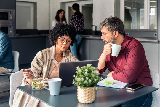 Business people working while lunch