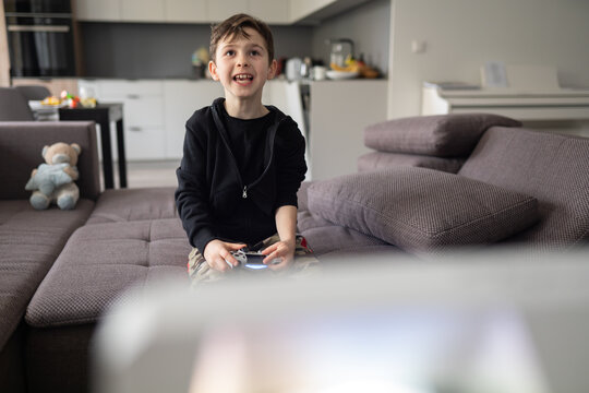 Little Boy Holding Video Games Controller Indoors