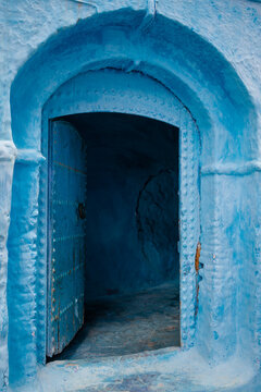 The open door in a blue building