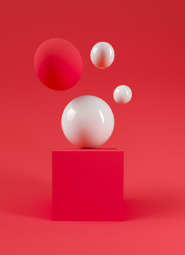 A White Ball Sitting On Top Of A Red Cube
