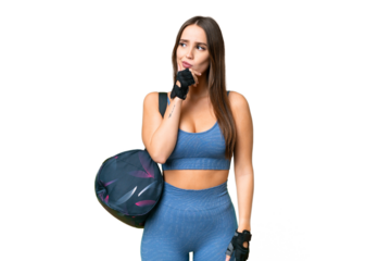 Young sport woman with sport bag over isolated chroma key background having doubts and with confuse face expression