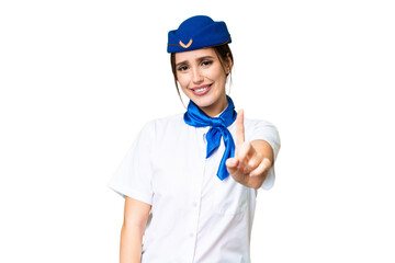 Airplane stewardess over isolated chroma key background showing and lifting a finger