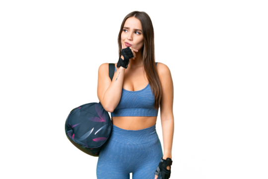 Young sport woman with sport bag over isolated chroma key background having doubts and with confuse face expression