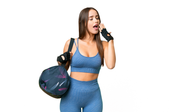 Young sport woman with sport bag over isolated chroma key background yawning and covering wide open mouth with hand