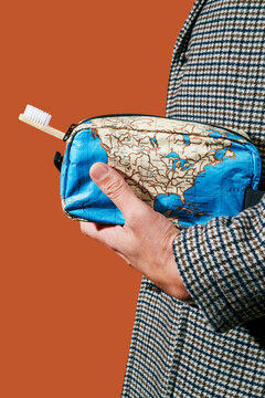 carries a map-patterned toiletry bag