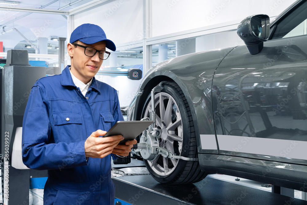 Poster serviceman with digital tablet on the background of the car in the car service