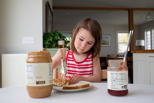 Child Makes Herself a Peanut Butter and Jelly Sandwich