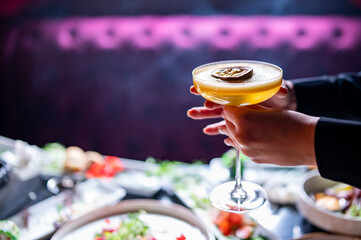 young waitress with cocktail drinks at restaurant