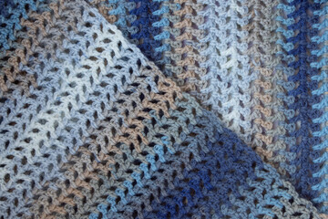 Fototapeta premium Close up colorful yarn texture background, beige, brown, white and blue strains. Shallow depth of focus. Knitting and crochet, craft work concept. Winter clothes. Color combination for styling.