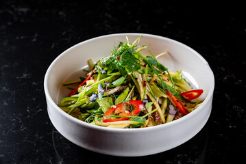 meat salad with vegetables on plate