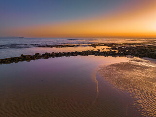 Sunrise over the sea and bay with clear skies
