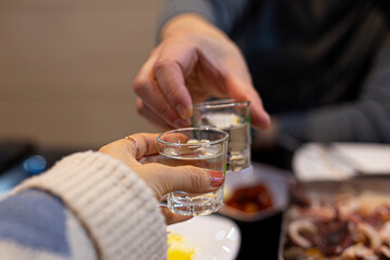 Obraz na płótnie Canvas Cheers with soju. Korean popular alcholic drink