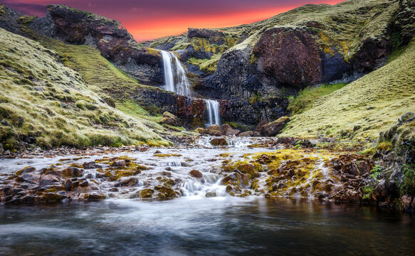 Icelandic Landscape. Scenic image of fairy-tale Stjornarfoss waterfall during sunset. Waterfall at Kirkjubaejarklaustur, Suourland or Southern Iceland, Europe. waterfall with colorful sky.