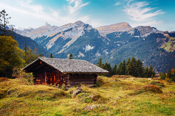 Fototapeta na wymiar Wonderful view of scenic mountain landscape in the Alps with traditional old mountain hut on highland. Amazing Nature Landscape. Awesome natural Background. Incredible colorful Scenery.