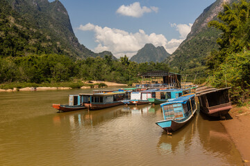 Fototapeta na wymiar Boats at Nam Ou river in Muang Ngoi Neua village, Laos