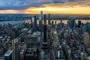 A rain storm over the Hudson Yards in New York City during beautiful sunset.