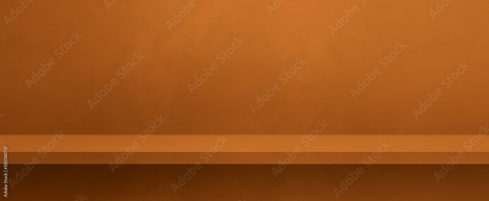 Wall mural Empty shelf on an orange brown concrete wall. Background template. Horizontal banner mockup