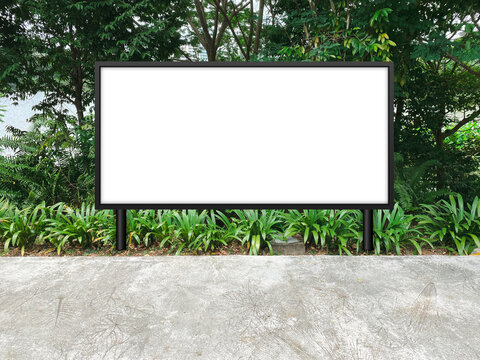 Large Horizontal Blank Advertising Poster Billboard Mockup, Framed By Trees And Plants, Lush. Straight Digital Light Box Display Screen For OOH Media. Out Of Home Template Beside Pedestrian Path