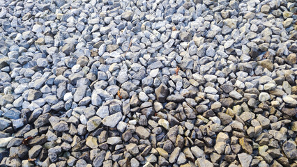 Gravel road stone texture. Gray gravel pattern. Closeup road with small rocks background