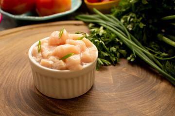 Small Raw Chicken Cubes on bowl, focused