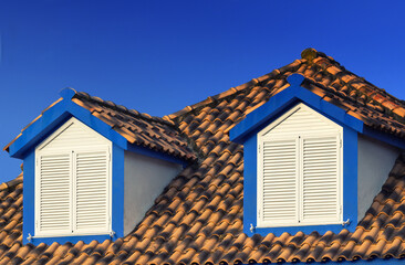 Fototapeta na wymiar House with a roof made of tiles. Close up of a Mediterranean style apartment.