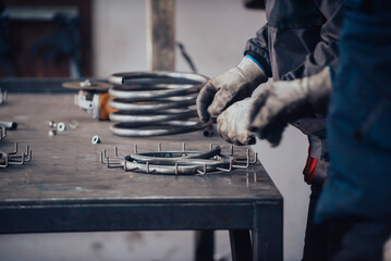 The locksmith measures the pieces of steel and preparing them for welding