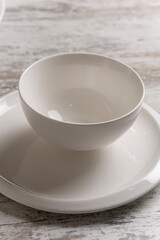 empty white plate on white wooden table