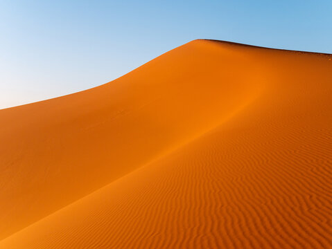 Intricate wavy patterns seen on dunes near Merzouga, Morocco during sunset - Landscape shot © Amine