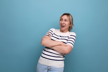 close up photo of adorable energetic happy blonde millennial woman in striped casual blouse on blue background with copy space