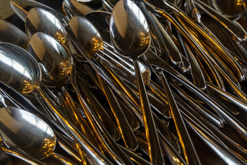 pile of spoons and forks
