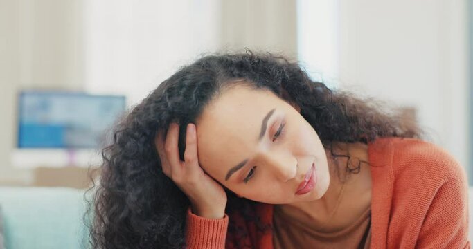 Woman, phone texting and reading on sofa in home lounge with stress, bored or frustrated for communication. Girl, smartphone and social media app on internet, web chat and thinking with annoyed face