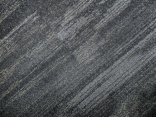 stock photo of a gray-colored, shaded diagonal stripe nylon cut pile textured carpet background. Picture captured at IT company office, Hyderabad, telangana, India.
