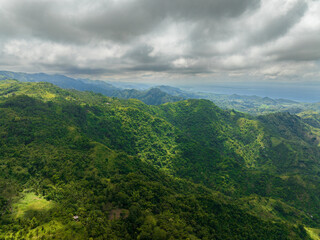Top view of mountains and hills with tropical vegetation and farmland. Negros, Philippines